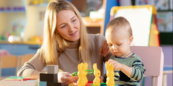 A mother and child in a nursery doing an activity