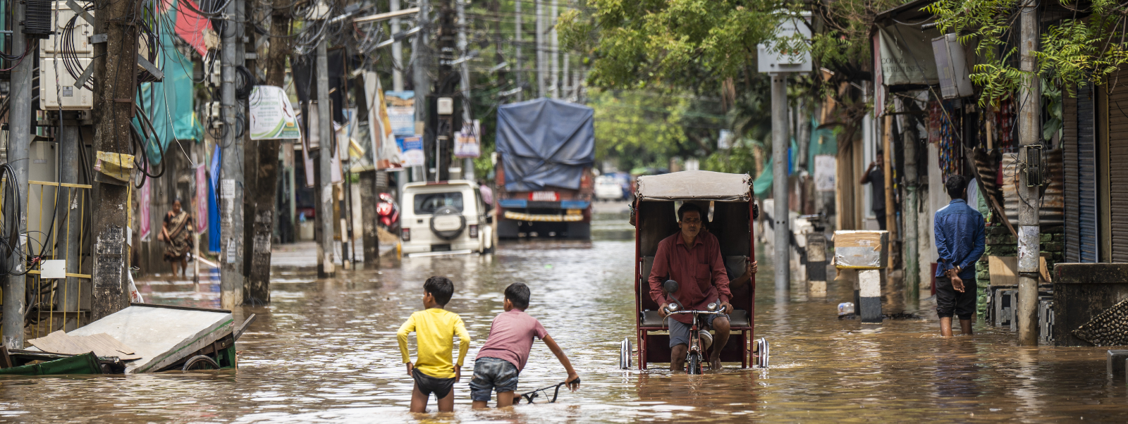 Children wading through a flooded street