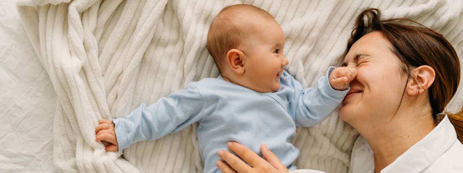 A baby and mother laughing