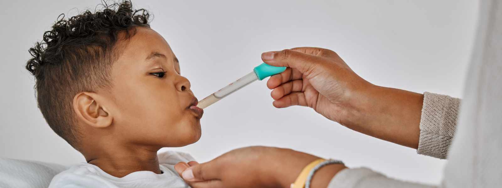 A child being given medicine.