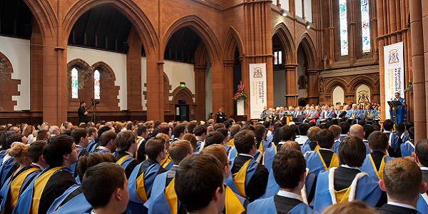 Students in graduation gowns sitting in the Barony Hall during the graduation ceremony.