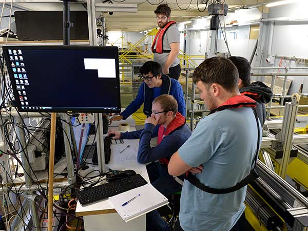 Students gathered round a computer.