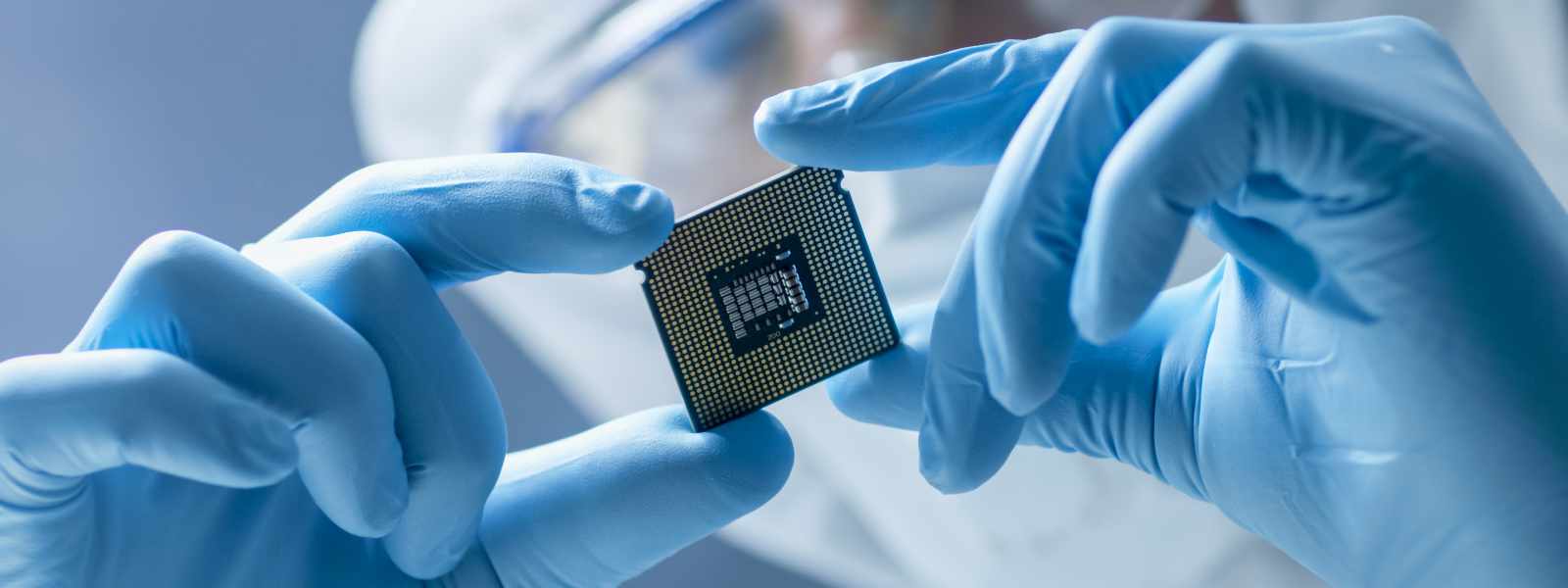 Gloved hands holding a medical chip