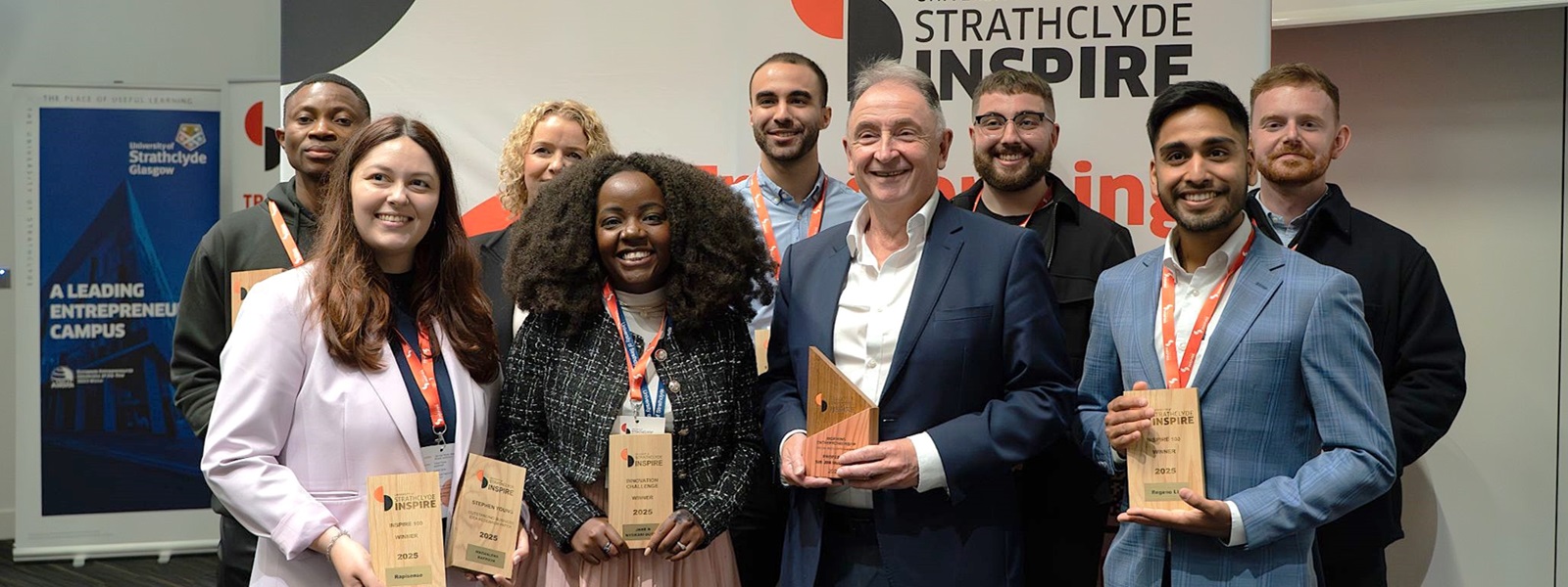 Professor Sir Jim McDonald with group of entrepreneurs awarded funding at strategy launch event.