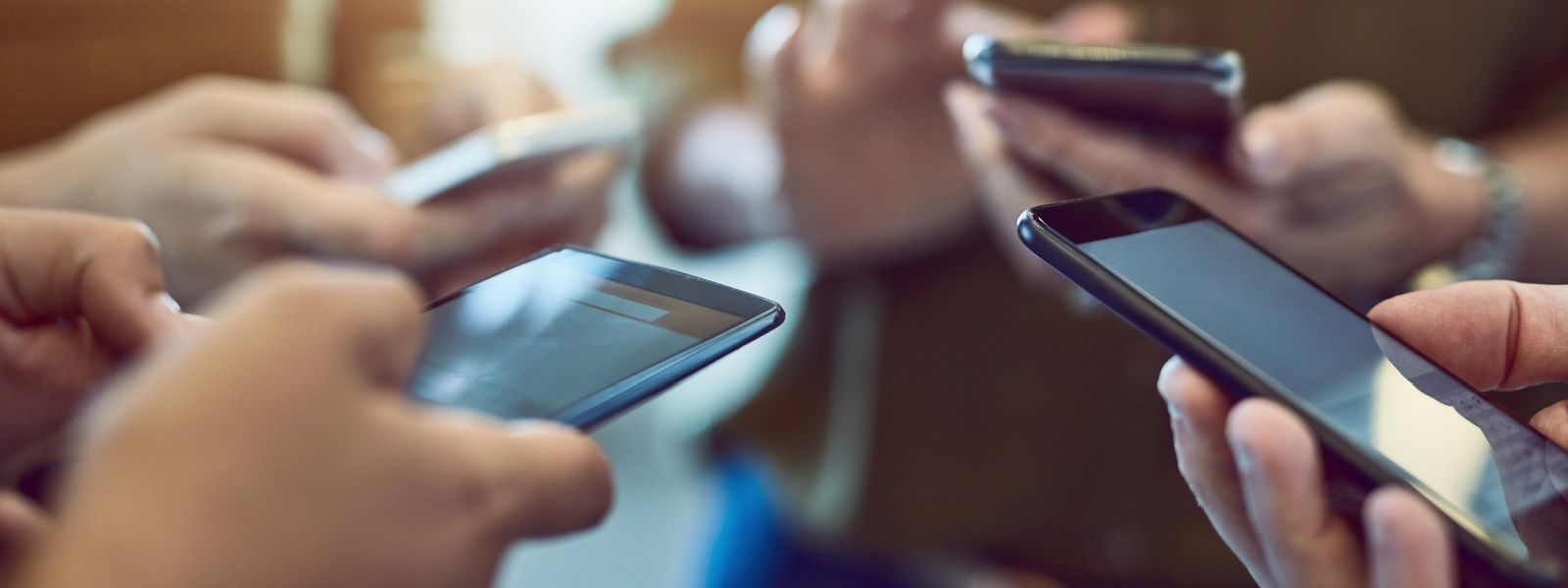 Close up image of people holding mobile phones