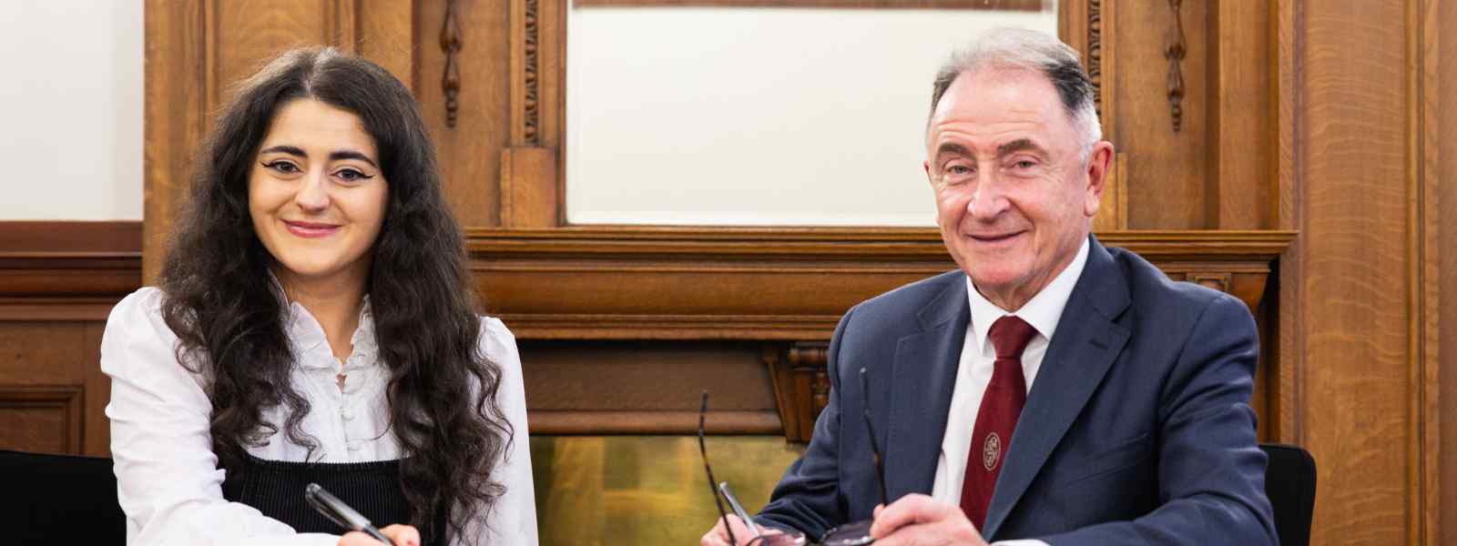 Students' Union president Eva Curran and Principal Professor Sir Jim McDonald sign the Strategic Alliance Framework document