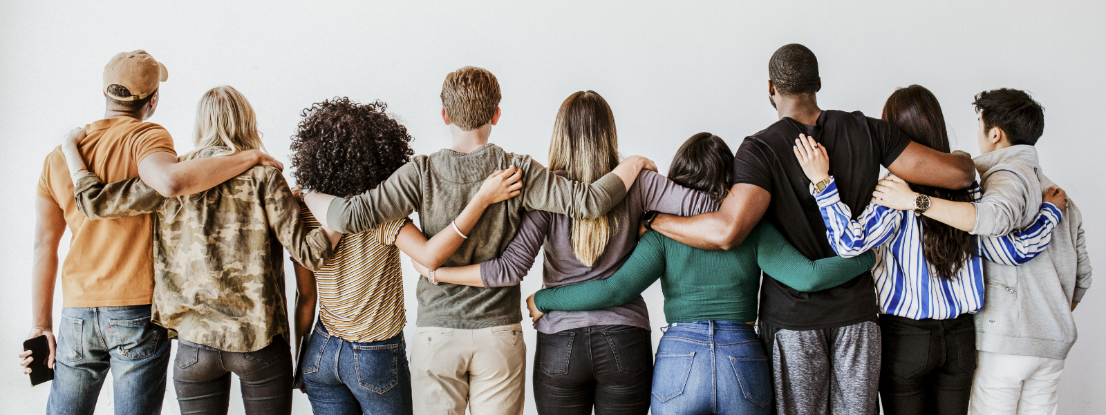 A diverse group of people hugging.